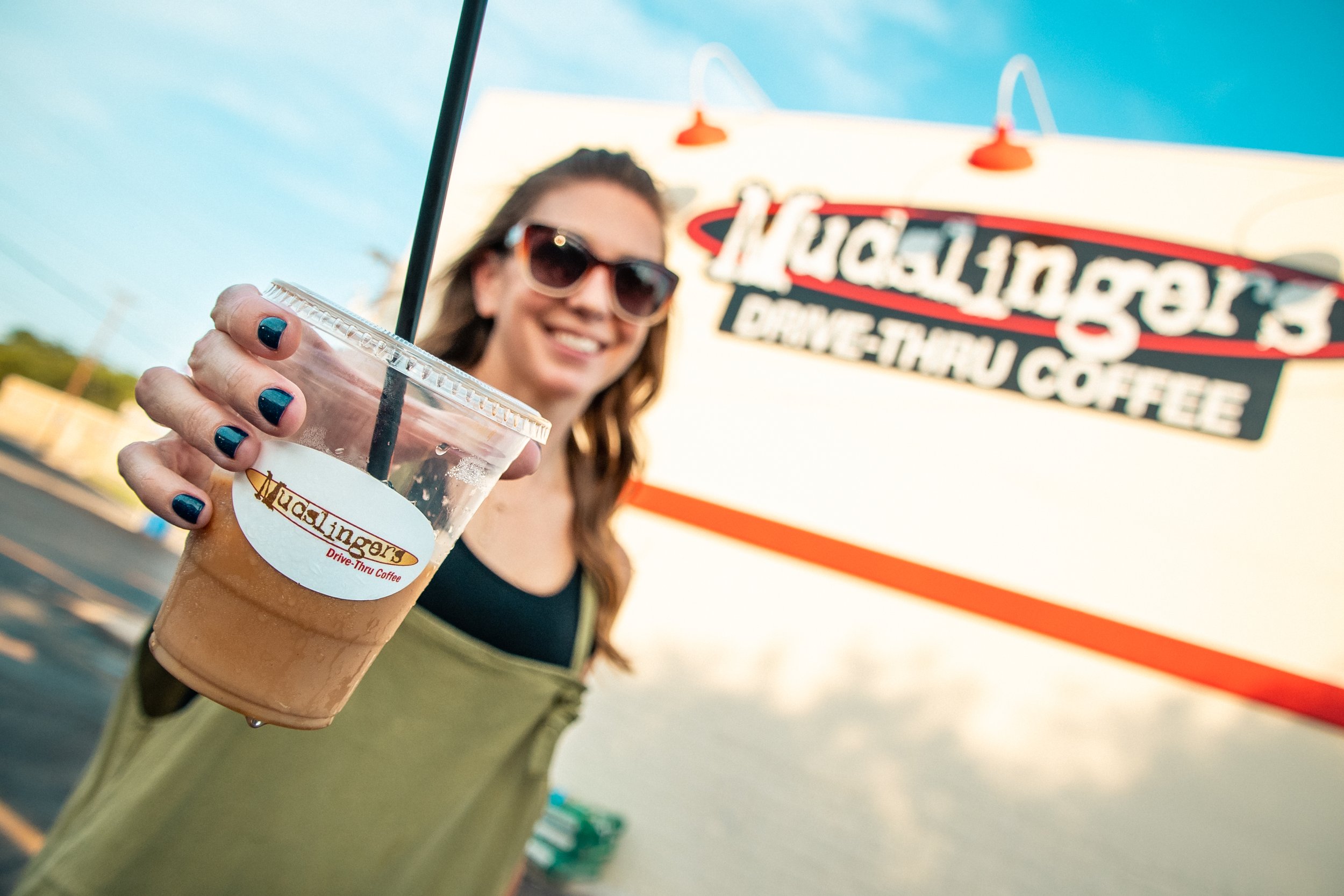 Lady holding Mudslingers low-calorie iced coffee drink